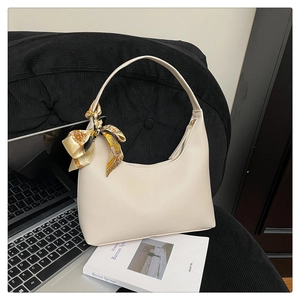 Detail of creamy white lychee leather hobo bag with vintage chain and silk scarf