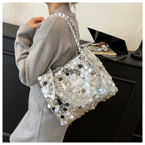 Detailed view of silver sequin tote bag with thick woven shoulder strap for women