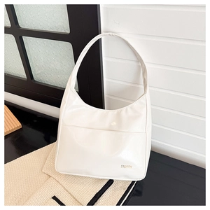 Detail of white hobo shoulder bag showing glossy PU leather texture and gold logo