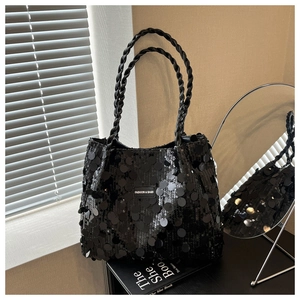 Detail of black sequined tote bag featuring a Fashion & Bags woven label and woven handles