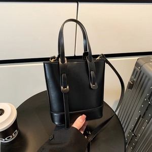 Sac seau noir minimaliste avec doubles poignées et bandoulière réglable pour le quotidien