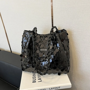 Chic black sequin tote bag with woven handles and fashion logo for autumn/winter 2025