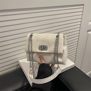 White suede pleated cloud bag with silver chain strap and rhinestone turn-lock