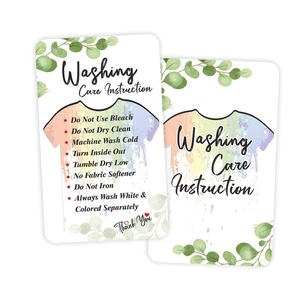 Clothing washing care instruction card with green eucalyptus leaves and garment care symbols