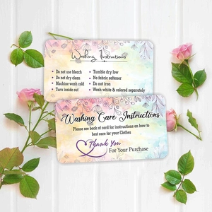 Detail of floral watercolor garment care instructions and thank you card on wood