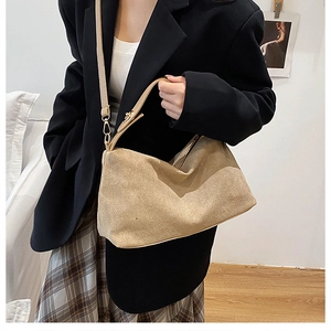 Khaki suede tote bag shown on a model with a minimalist urban professional look