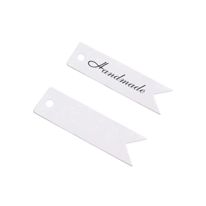 Close-up of white swallowtail gift tags with Handmade print and pre-punched holes