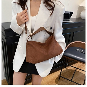 Brown suede slouchy shoulder bag styled with broad leather strap for office commute