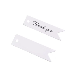 Close-up of white fishtail paper gift tags with Thank You print and hanging holes