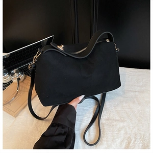 Top-down view of black large-capacity commute handbag with golden hardware and dual straps