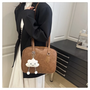 Brown vintage leather bowling bag with cute plush cloud charm and silver hardware