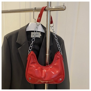 Detail of red patent leather crescent bag with silver chain strap and fashion text
