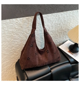 Detailed laser-cut flower patterns on dark brown suede matte tote bag surface