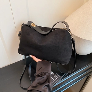 Minimalist black suede tote bag for women with elegant gold hardware and shoulder strap