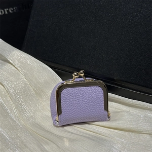 Purple mini lychee leather clasp purse with gold frame on white silk and dark background