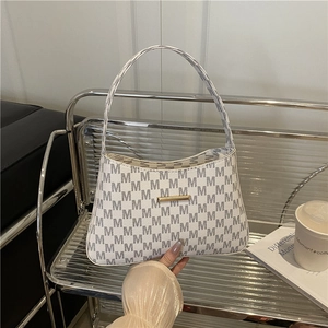 Chic white bucket bag with grey M-pattern print and gold metal bar detail for women
