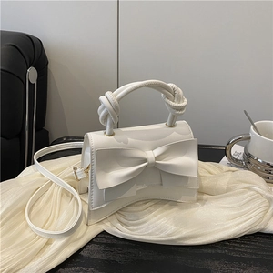 Chic white bow shoulder bag with twisted handle and detachable strap for women