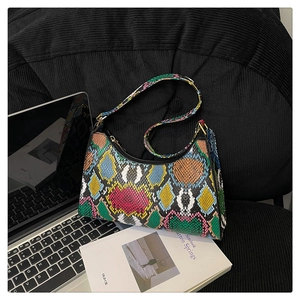 Detail shot of colorful snakeskin hobo bag with vibrant green and pink patterns