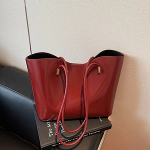 Classic red vintage tote bag in high-shine leather with gold hardware and slim handles