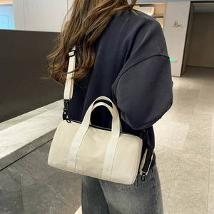 Detail of cream nylon barrel bag with detachable coin purse and adjustable strap