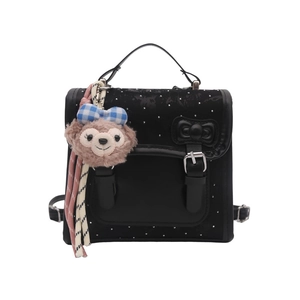 Minimalist black bow backpack with metallic buckle and plush cartoon mascot charm