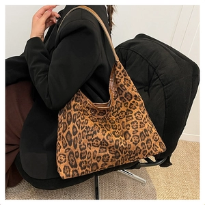 Detail of large leopard print tote bag styled with a professional black blazer outfit