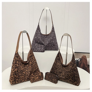 Three leopard print hobo bags in dark brown, tan, and grey with matching small pouches