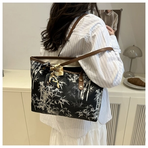 Lifestyle shot of large tote bag with bamboo print and silk scarf on a model