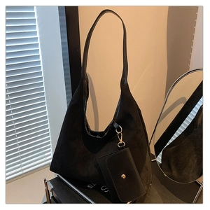Macro view of black frosted suede hobo bag with a detachable mini snap coin pouch