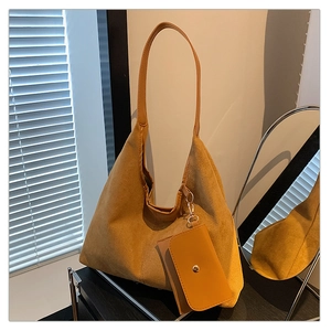 Detail of yellow suede tote bag with matching coin purse and bohemian slouchy design