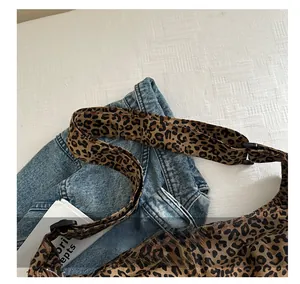 Detail of the leopard print canvas bag showing the adjustable wide shoulder strap
