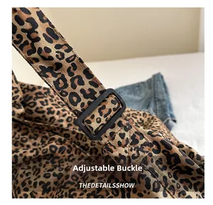 Detail of adjustable black buckle on leopard print canvas bag with durable strap