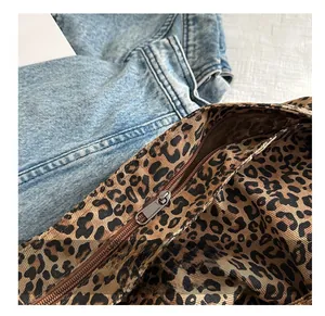 Close-up of high-quality smooth metal zipper on leopard print canvas tote bag