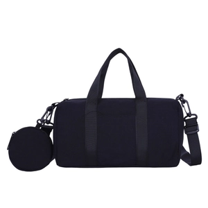 Minimalist black nylon barrel bag with adjustable strap and small round coin purse
