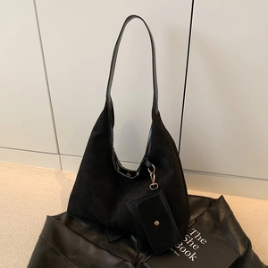 Minimalist black suede hobo bag with leather handle and detachable pouch accessory
