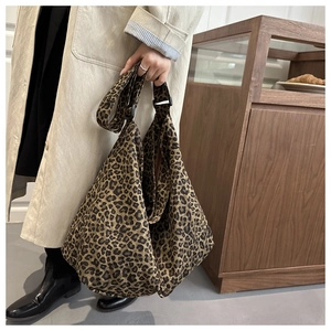 Close-up of leopard print canvas tote bag with adjustable shoulder strap and large capacity