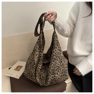 Leopard print canvas tote bag with wide strap styled for casual daily fashion look