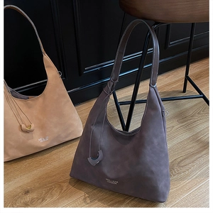 Detail of vintage suede hobo tote bags in light camel and dark coffee with wide straps