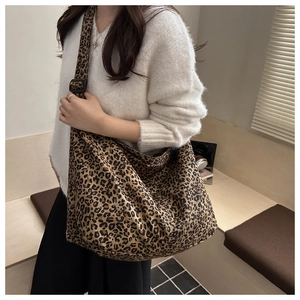Detail of large leopard print canvas tote bag with adjustable wide shoulder strap