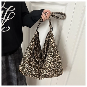 Macro detail of the leopard print canvas fabric on a large hobo style tote bag