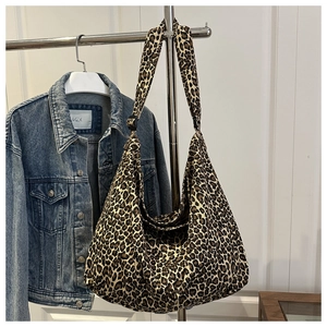 Close-up of leopard print canvas tote bag with adjustable wide shoulder strap details
