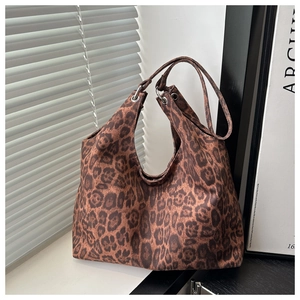 Close-up of leopard print velvet tote bag with reinforced silver metal grommets
