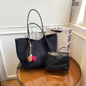 Large black faux suede tote bag with matching leather pouch and pompom charm detail