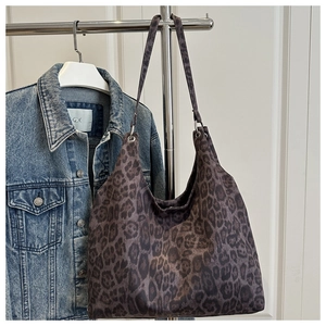 Detail of leopard print suede tote bag featuring slim shoulder straps and large capacity