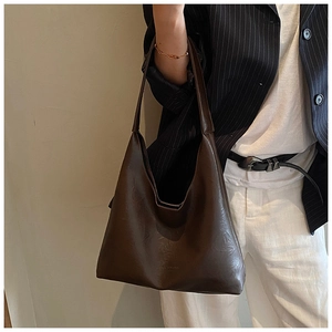 Deep brown large leather hobo bag styled with a professional suit for a minimalist office look