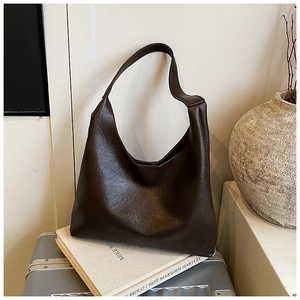Close-up of dark brown leather tote showing soft texture and Fashion & Bags embossed logo