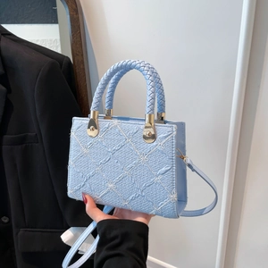 Light blue small square handbag with quilted bow embroidery and woven handle