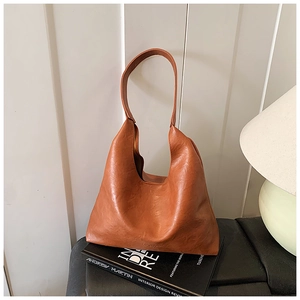 Detailed view of caramel brown hobo bag with soft leather texture and premium stitching