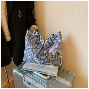 Detail of blue and white geometric woven canvas tote bag with adjustable wide strap