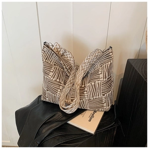 Close-up of vintage knit tote bag with geometric wave patterns and wide strap